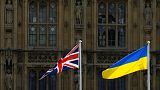 A Union Jack flag and a Ukraine flag fly in front of the Houses of Parliament on Ukraine Independence Day in London, Wednesday, Aug. 24, 2022.