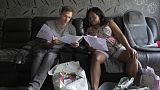 Sadie James, right, and Jon Taylor, a debt manager at the charity Christians Against Poverty, read the documents from a housing association at her home, in London, 2023.