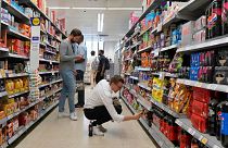 Shoppers buy food in a supermarket in London, Wednesday, Aug. 17, 2022.