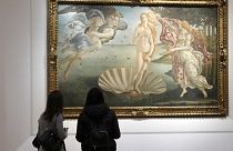 Two visitors admire 15th century painter Sandro Botticelli's Birth of Venus inside the Uffizi Gallery museum in Florence, Italy, Jan. 21, 2021.