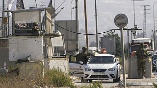 Israeli soldiers check a Palestinian car at the Hawara check point in the West Bank, Saturday, Aug. 19, 2023