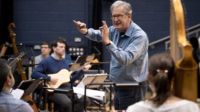 British composer Sir John Eliot Gardiner conducts the orchestra during a rehearsal session at Sadler's Wells Theatre in London.