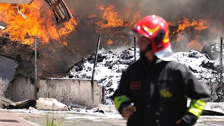 Italian Firefighters work to extinguish a fire which broke out in a garbage dump near Ciampino Airport in Rome, Saturday, July 29, 2023.